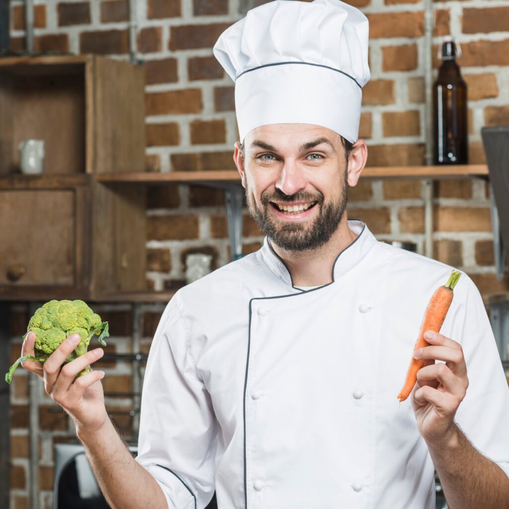 Curtis James Chef Curtis James flipping vegetables in a pan with a joyful smile