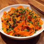 carrot ribbon salad with soy dressing and chili crisp