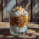 Frozen dalgona coffee in glass over iced oat milk