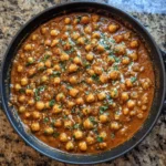 Skillet of creamy butter chickpeas with cilantro on top